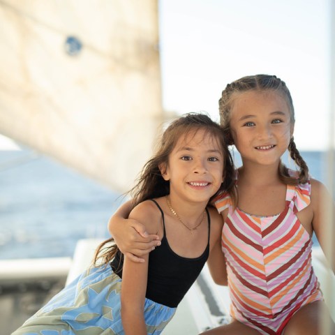 a little girl sitting at a beach